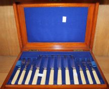 A mahogany cased set of electroplated fruit knives and forks and fish knives and forks