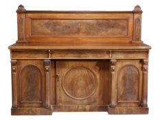 A Victorian mahogany sideboard, circa 1870, with a rear panelled gallery, the base with three