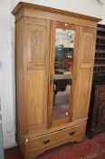 An Edwardian walnut wardrobe, single mirrored door with drawer below 199cm high, 116cm wide