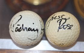 Two signed golf balls, one bearing the signature Justin Rose, the other Pádraig Harrington (