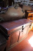A Victorian mahogany chiffonier with a carved shield back and two frieze drawers and cupboards