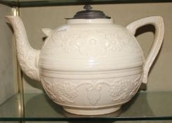 A large 19th Century white ground teapot with pewter lid; 22cm high