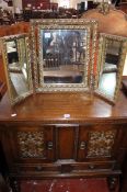 An 17th Century style carved oak cabinet 85cm high, 91cm wide and a dressing table mirror