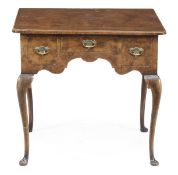 A walnut lowboy in George II style, 20th century, the rectangular top with re-entrant corners above