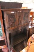 A German style ""Augsburg"" style cabinet with two cupboards flanking carved soldier with two