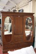 An Edwardian mahogany and inlaid triple section wardrobe 206cm high, 183cm wide