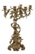 A French gilt bronze six light candelabrum in Louis XV style, early 20th century, the foliate cast