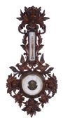 A Black Forest carved and stained wood wall barometer, late 19th century, the aneroid movement with