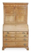 A George III oak bureau bookcase, circa 1780, with a moulded cornice with chequer inset bands,