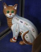 A Galle style polychrome painted ceramic cat with green glass eyes; 32cm high and another similar