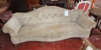 A Victorian walnut serpentine fronted sofa with an arched button back scrolled arm supports 212cm