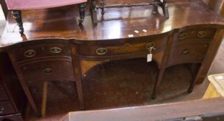 A George III mahogany and inlaid serpentine sideboard c1780, the top above a central drawer flanked