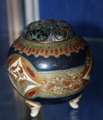 A small Japanese earthenware pot pourri held on three feet with pierced metal cover; approximately