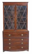 A George III mahogany secretaire bookcase, circa 1780, with a moulded cornice above a pair of
