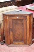 A 19th century elm small hanging corner cupboard Best Bid