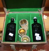 A leather travelling case, compartmentalised for transporting/storing four bottles of Gordons gin (