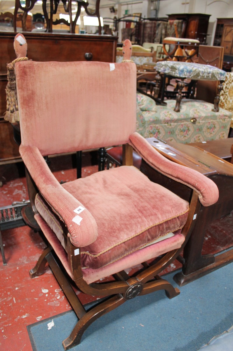 A 17th Century style X-frame upholstered armchair, cast iron fire back, grate and pair of steel