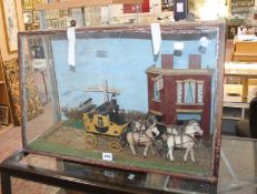 A glazed cased diorama of coach and horses with sign post for Hastings and London; 43cm high x 67cm