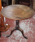 A George III mahogany tilt top tripod table 70cm high, 73cm diameter and a 17th Century panelled