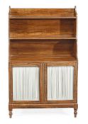 A Regency simulated rosewood waterfall bookcase, circa 1815, with two shelves above a cupboard base