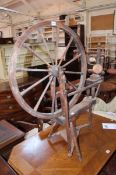 A 19th Century pine spinning wheel. Best Bid