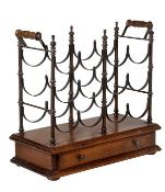 A stained beech and metal mounted table top wine rack in 19th century style, the three tiers of