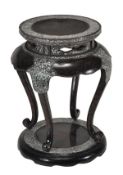 A Japanese or Korean lacquer stand or table, of waisted circular section raised on four cabriole