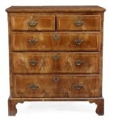 A George II walnut chest of drawers,  circa 1740, the rectangular holly string top with moulded