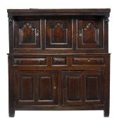 An oak court cupboard, dated 1755, the upper section with three arched moulded panels incorporating