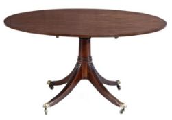 A George III mahogany oval topped dining table, circa 1780, the oval top with a reeded top, on