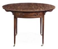 A Regency mahogany oval Pembroke table, circa 1815, the oval top incorporating a pair of hinged