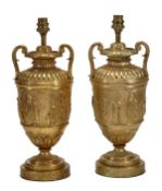 A pair of gilt metal twin handles urns fitted as table lamps, mid 20th century, the scrolling