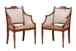A pair of Sheraton Revival painted beech bergere elbow chairs, last quarter 19th century, each