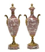 A pair of gilt metal mounted mottled pink and white marble urns in 18th century taste, early 20th