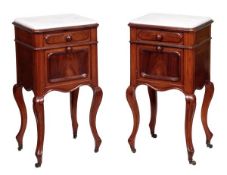 A pair of Victorian mahogany bedside cupboards, circa 1870, each white marble inset top above a