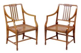 A pair of painted beech and caned armchairs in George III Sheraton style, 20th century, painted