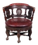 A Dutch Colonial carved oak and leather Burgomeister armchair, late 19th century, the crescent