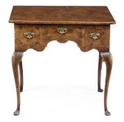 A walnut lowboy in George II style, 20th century, the rectangular top with re-entrant corners