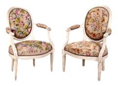 A pair of French painted cream open armchairs, late 19th/early 20th century, the oval backs above