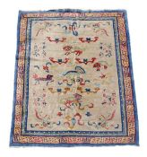 A Chinese carpet, the ivory field decorated with a polychrome dragon within conforming foliate