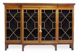 A mahogany breakfront bookcase, 19th century and later, with a dentil moulded cornice, above
