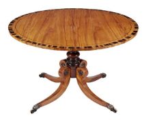 A Regency mahogany and coromandel crossbanded circular centre table, circa 1815, the top with