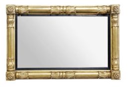A George IV carved giltwood and composition overmantel mirror, circa 1825, the rectangular plate