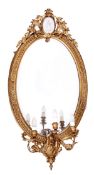 A Victorian giltwood and composition girandole mirror, circa 1870, the oval plate within a