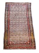 A Malayir long rug, the ivory field profusely decorated with floral motifs, within red borders and d