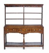 A George III oak dresser, circa 1780, with an open plate rack with metal hooks,the base with three d