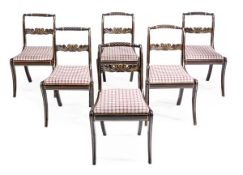 A set of six George IV simulated rosewood and parcel gilt dining chairs, circa 1825, the shaped