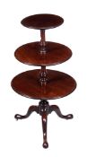 A George III mahogany three tier dumb waiter, circa 1780, each circular tier with shallow moulded