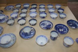A selection of mostly English blue and white porcelain tea cups and saucers including New Hall,