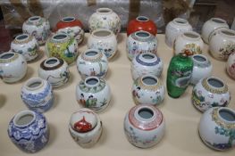 A collection of thirty English and Oriental polychrome decorated ginger jars (lacking covers), etc.